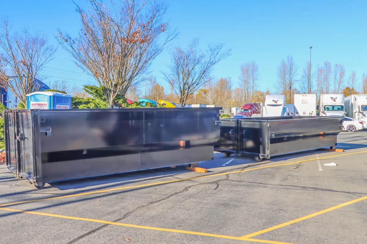 Professional dumpster rental service with roll-off container on residential driveway in Waite Park